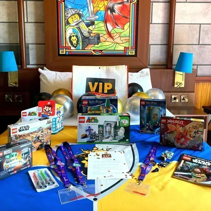 A bed in the LEGOLAND Castle Hotel with lots of LEGO, balloons and VIP lanyards